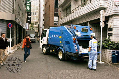 Garbage man and truck, at an alley in Shinjuku