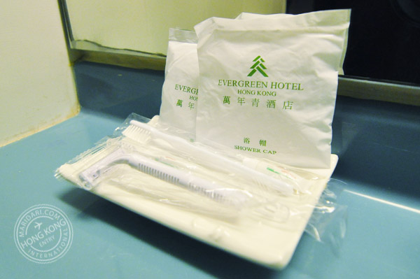 Evergreen Hotel Hong Kong bathroom amenities - toiletries including toothpaste, toothbrush, shower cap and shaving razor