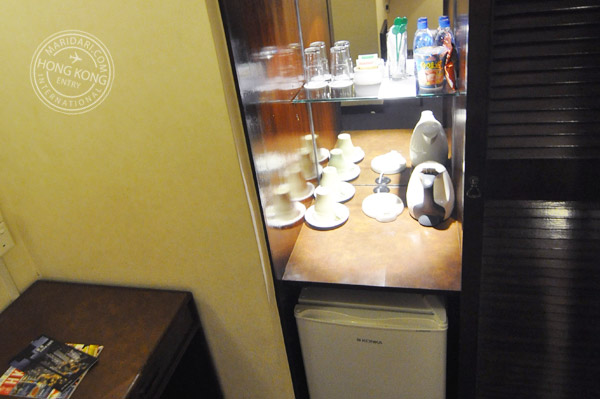 Evergreen Hotel Hong Kong in-room facilities and amenities - coffee and tea sachets, cups, saucers, drinking glasses, kettle