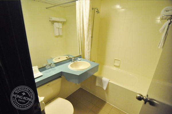 Evergreen Hotel Hong Kong bathroom - clean bath tub, sink, counter top and toilet bowl