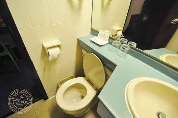 Evergreen Hotel Hong Kong bathroom - clean toilet with hairdryer, shower caps, shaving razor, toothbrush and toothpast provided