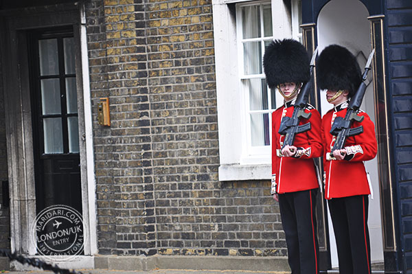 Caught off-guard - a Queen's Guard wearing a bearskin helmet glancing at the crowd snapping pictures. The sentry was in the middle of a guard change.